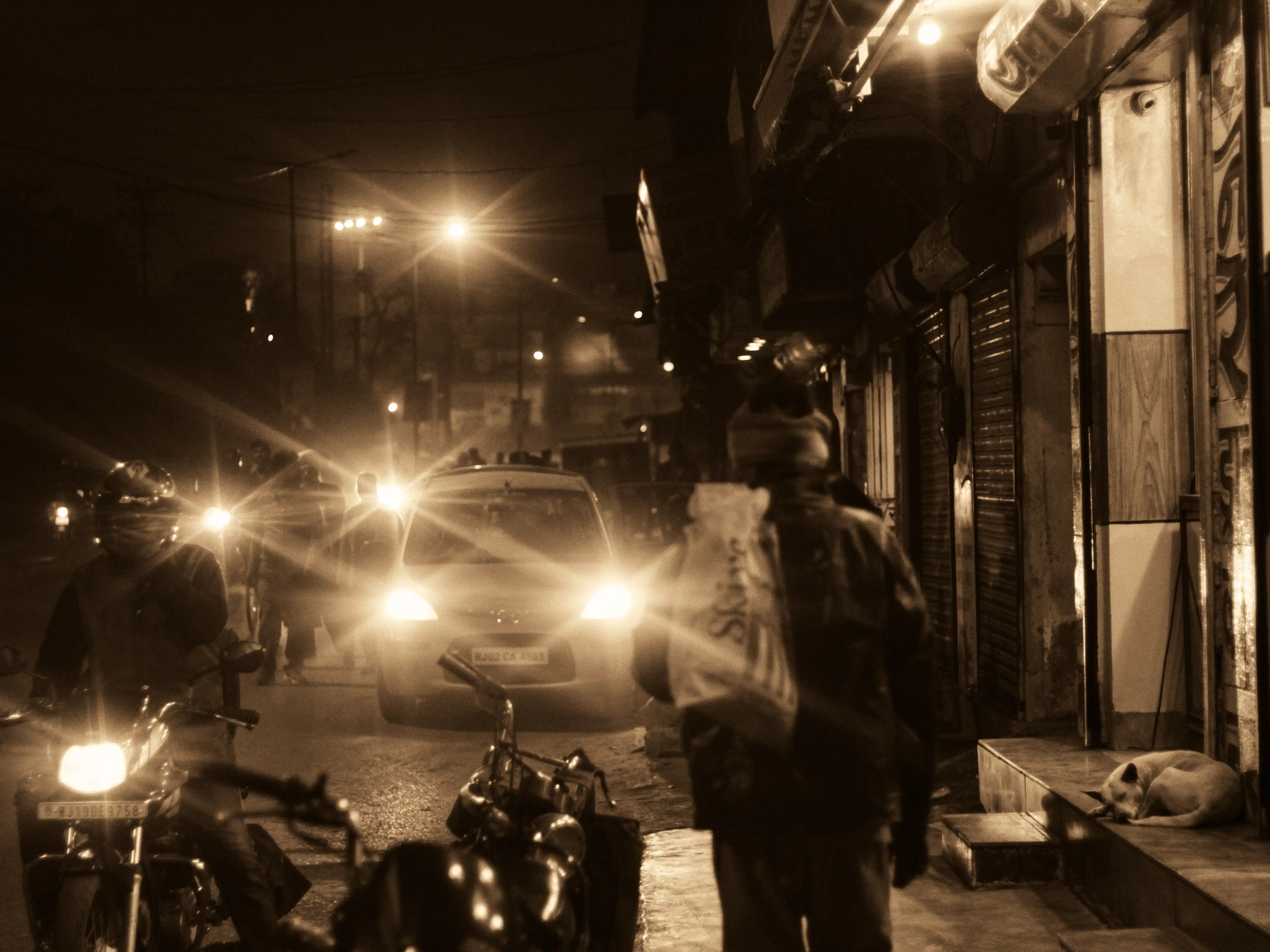 walking along a cold street of Jodhpur with blinding vehicular lights