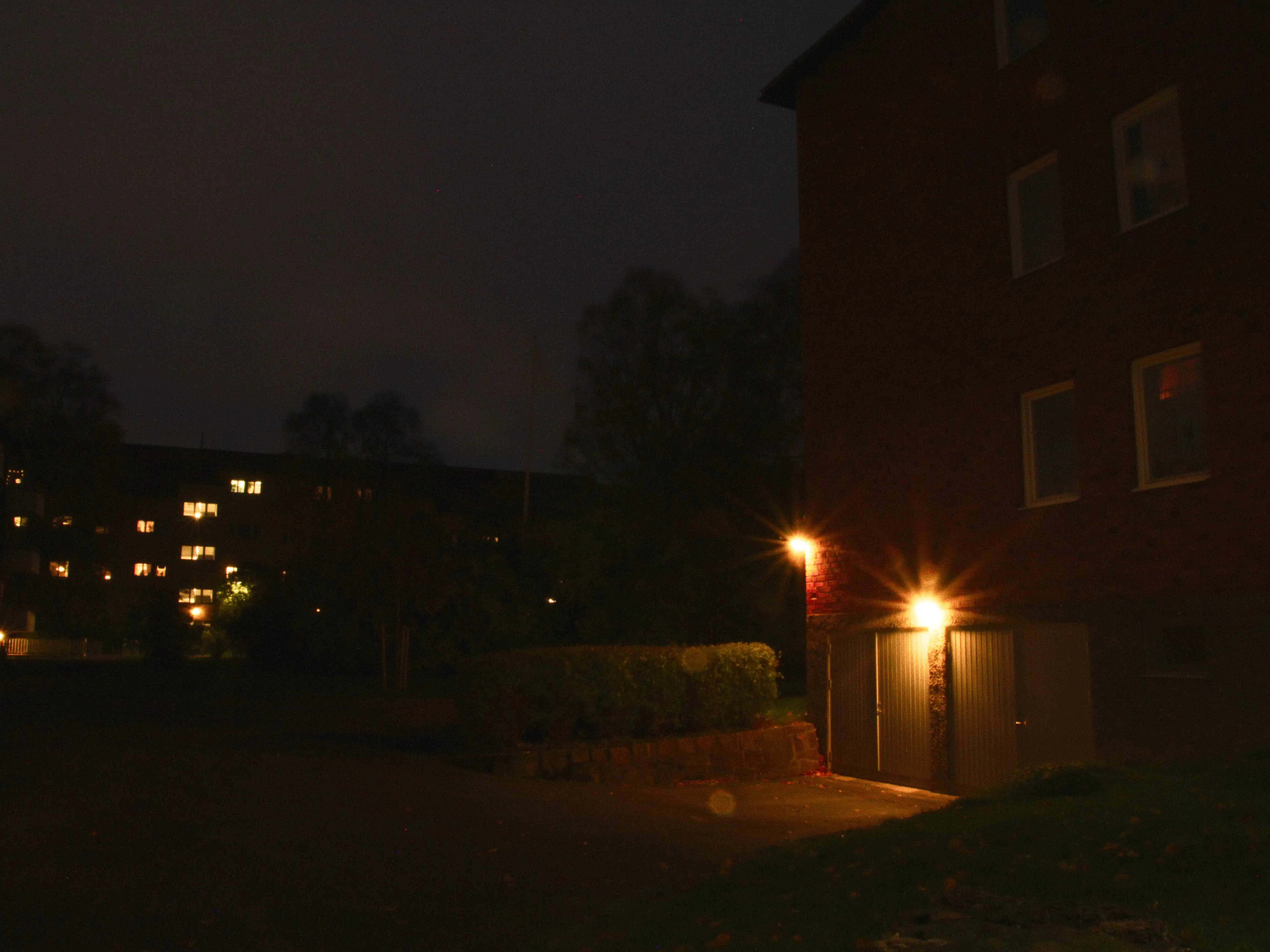 view of a parking garage at the backyard of an apartment building.