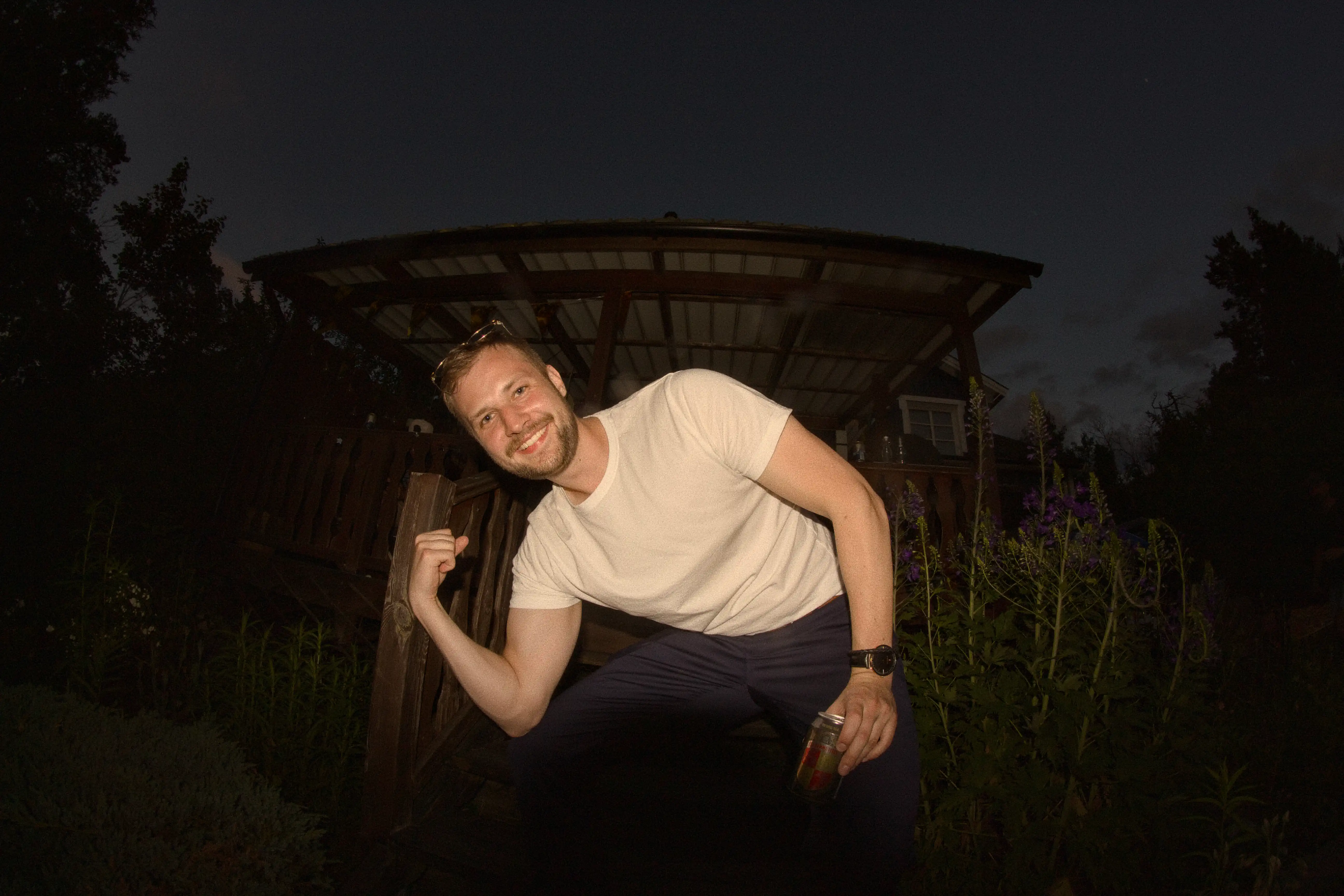 A friend flexing his arm and posing for a photo during a Midsommar celebration