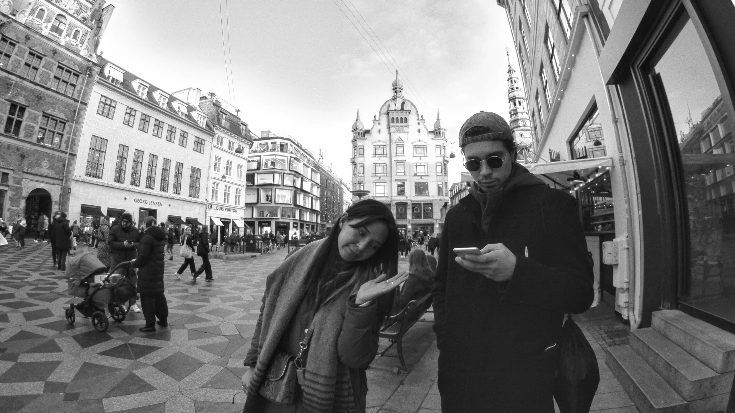 A man and a woman posing for a photo on the streets of Copenhagen
