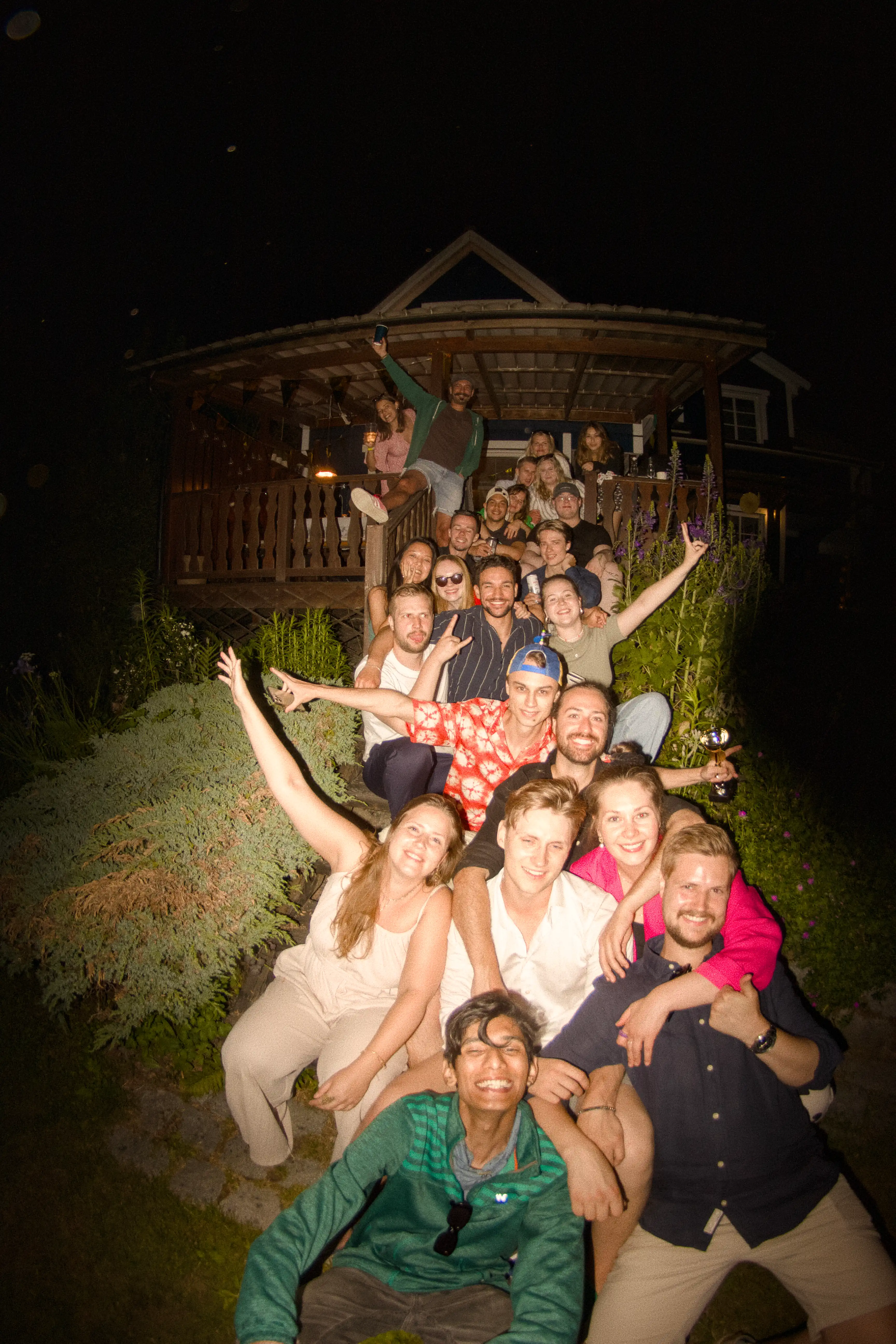 A large group of people posing for a group photo during a midsommar celebration