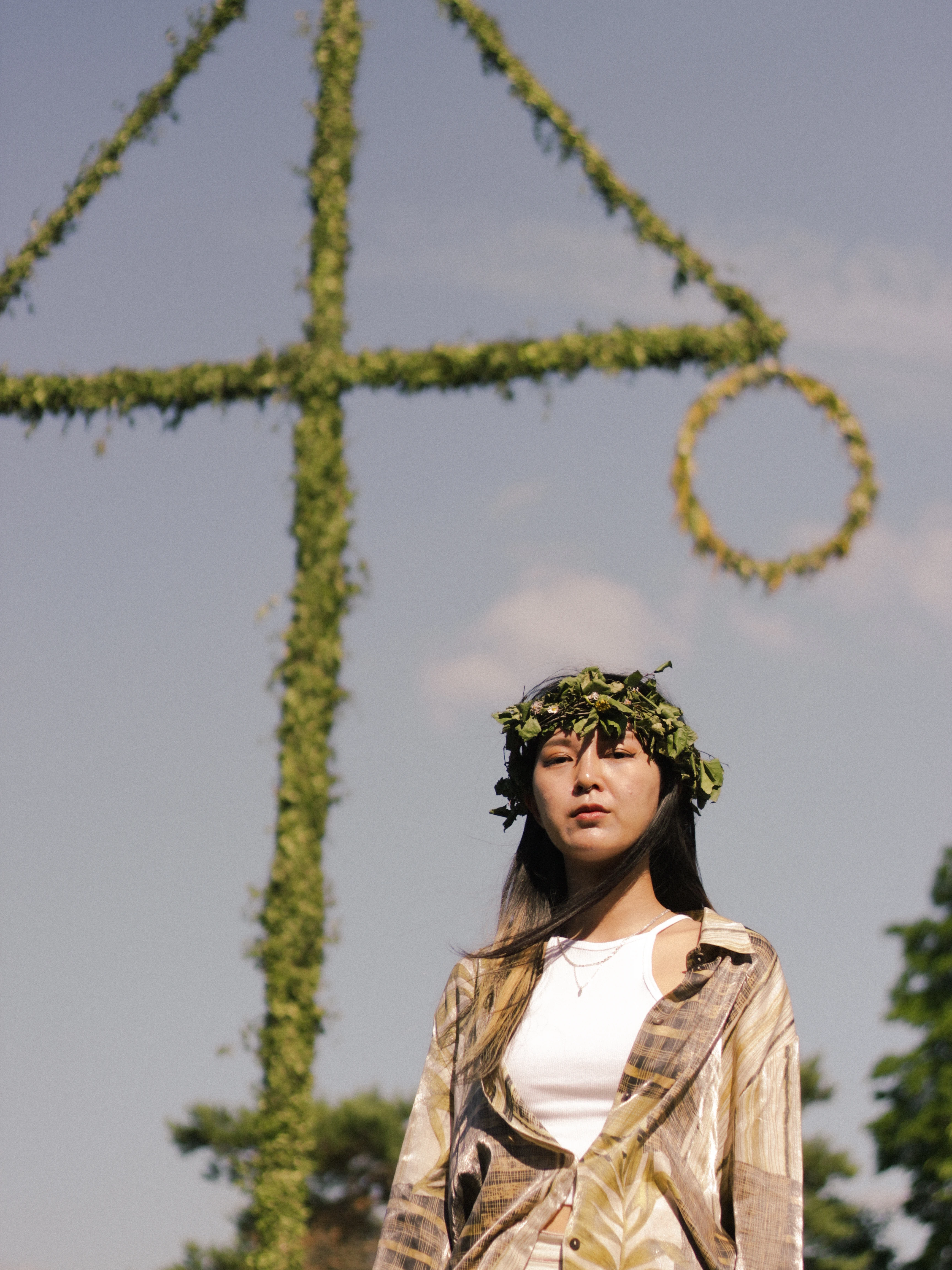 Portrait of a woman standing beside a Maypole at a Swedish Midsummer celebration