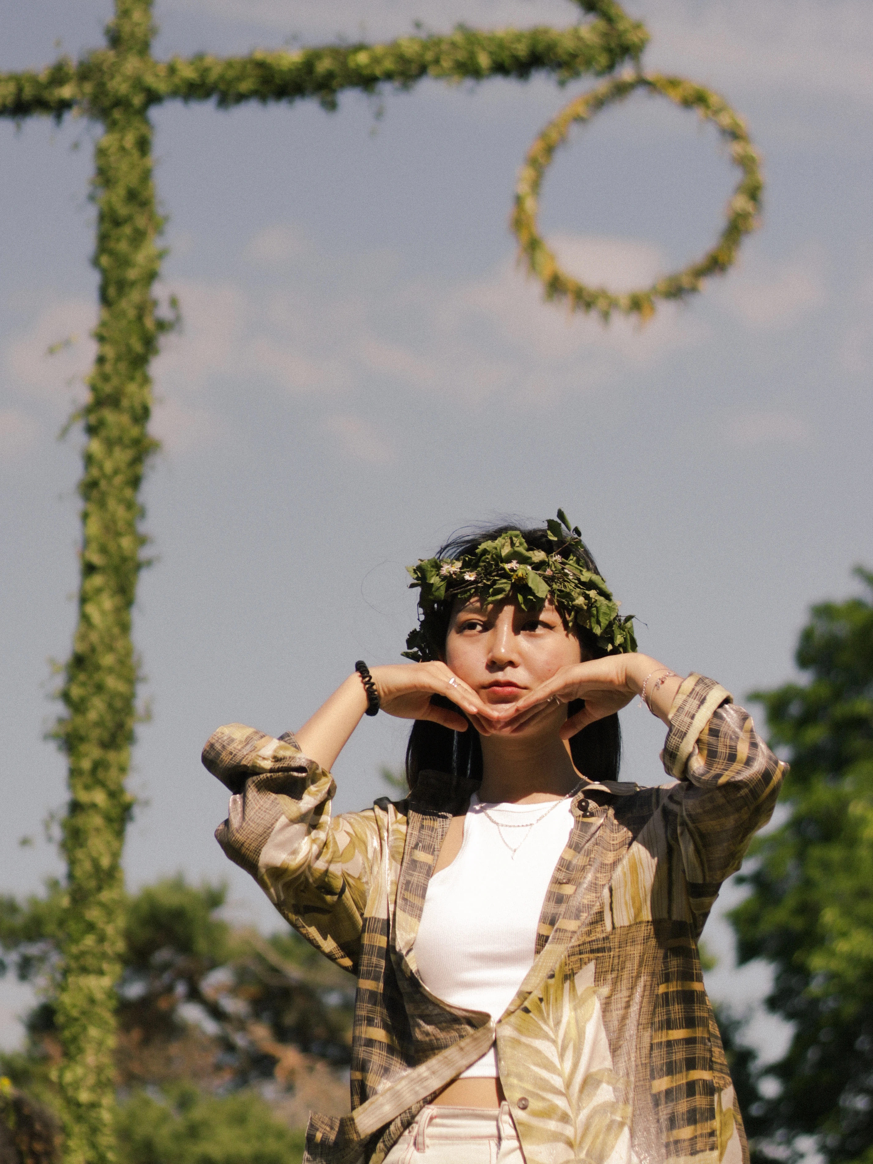 Portrait of a woman standing beside a Maypole at a Swedish Midsummer celebration